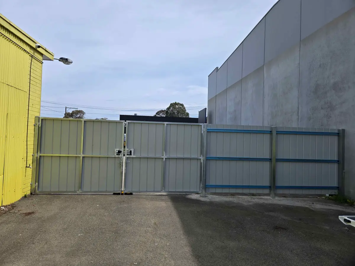 Galvanised steel framed Colorbond double gates and fence at an industrial site